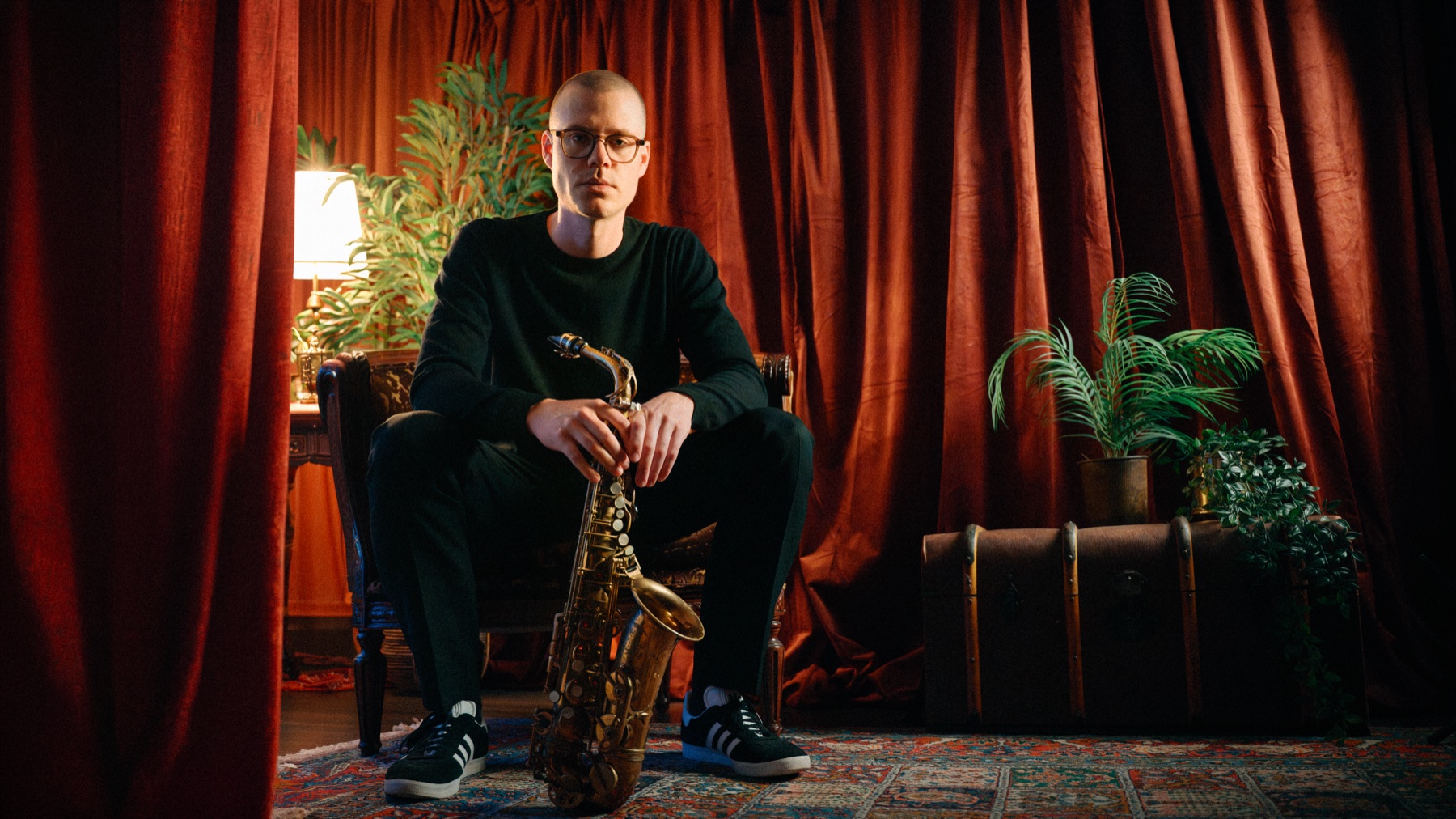 Johan Christoffersson seated with his saxophone